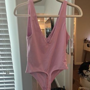 Aritzia pink medium body suit. Never worn. Can’t return.